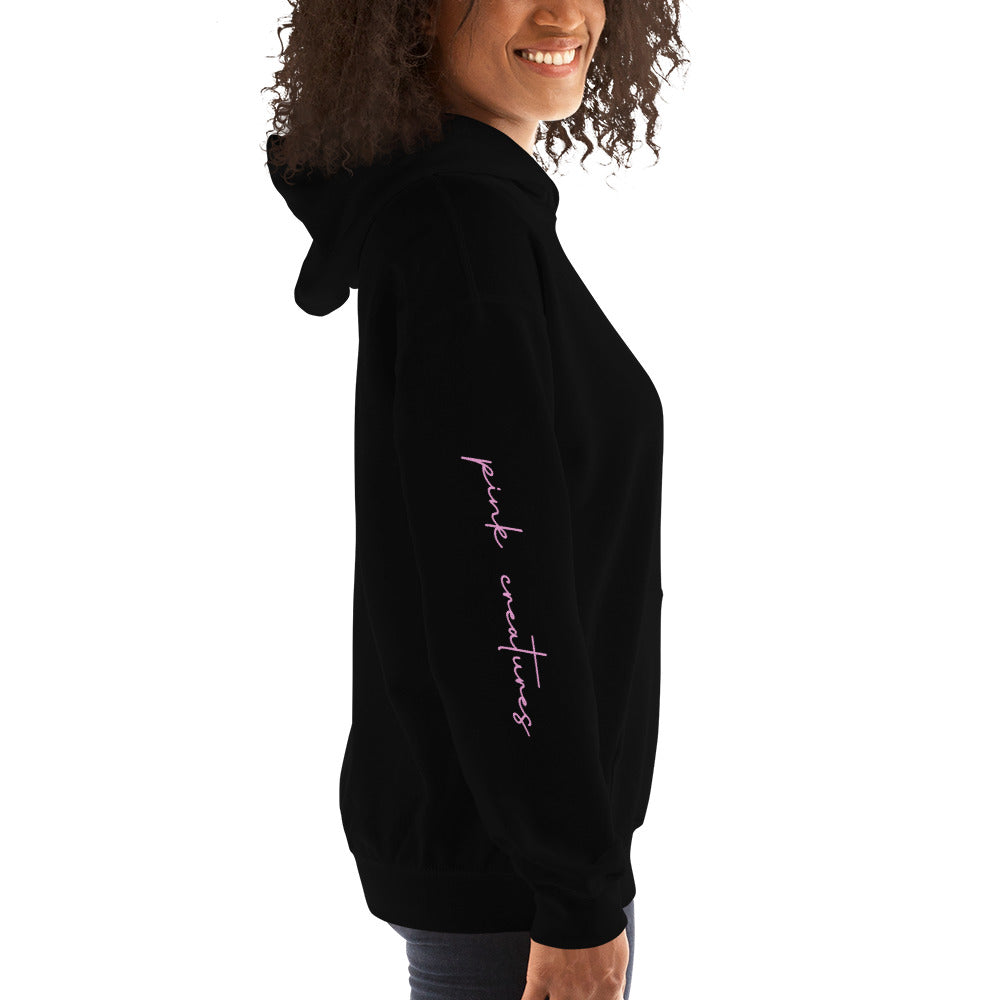 pink creatures title in pink hoodie