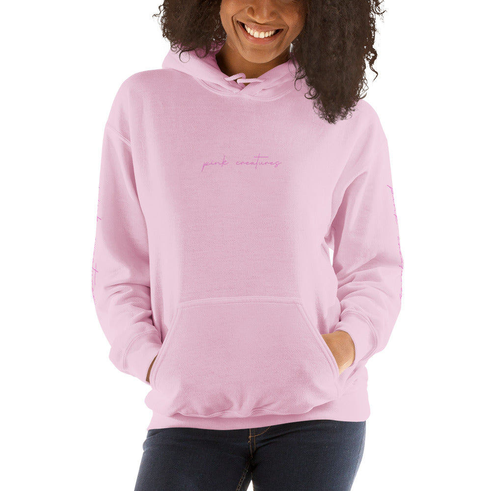 pink creatures title in pink hoodie