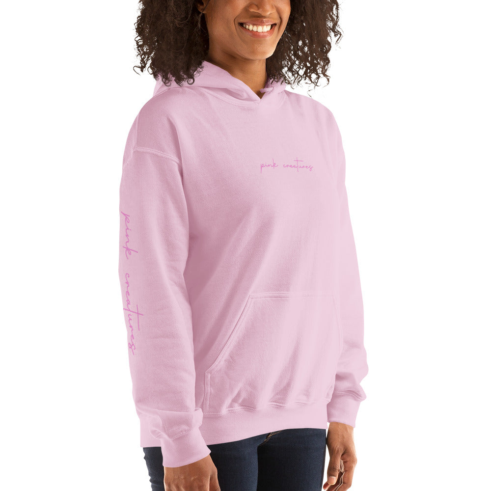 pink creatures title in pink hoodie