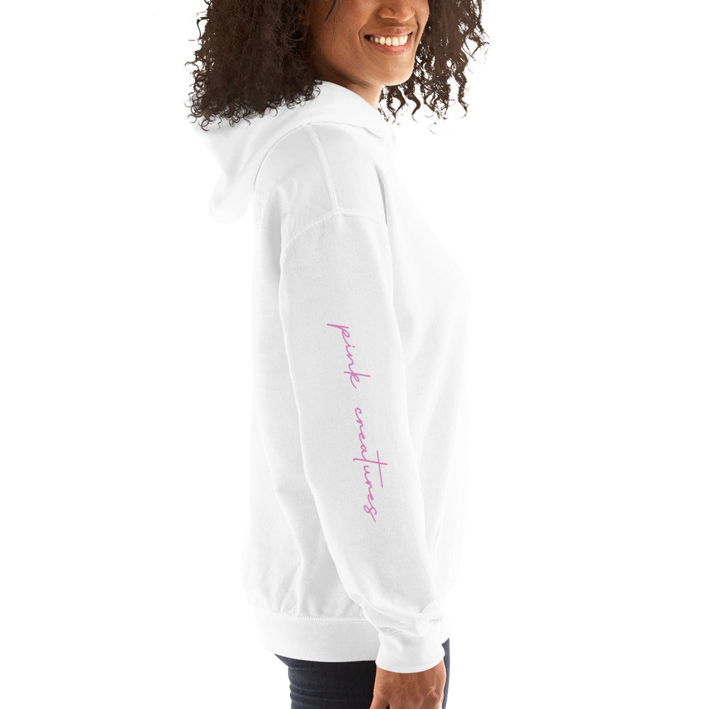 pink creatures title in pink hoodie