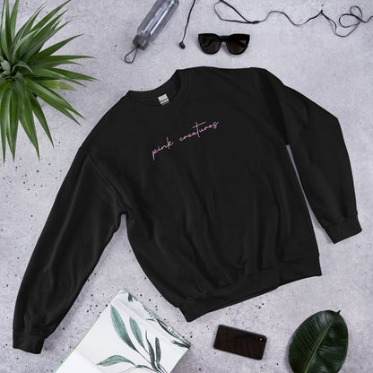 pink creatures title in pink crew neck