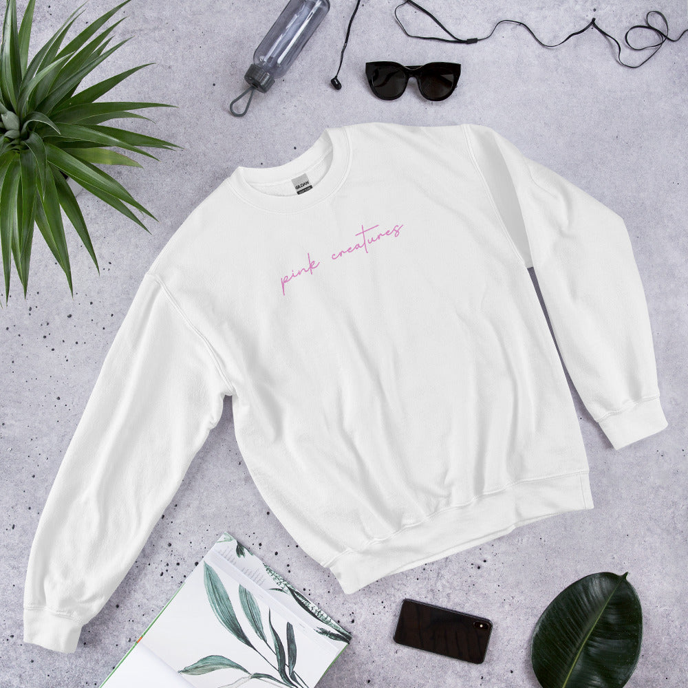 pink creatures title in pink crew neck