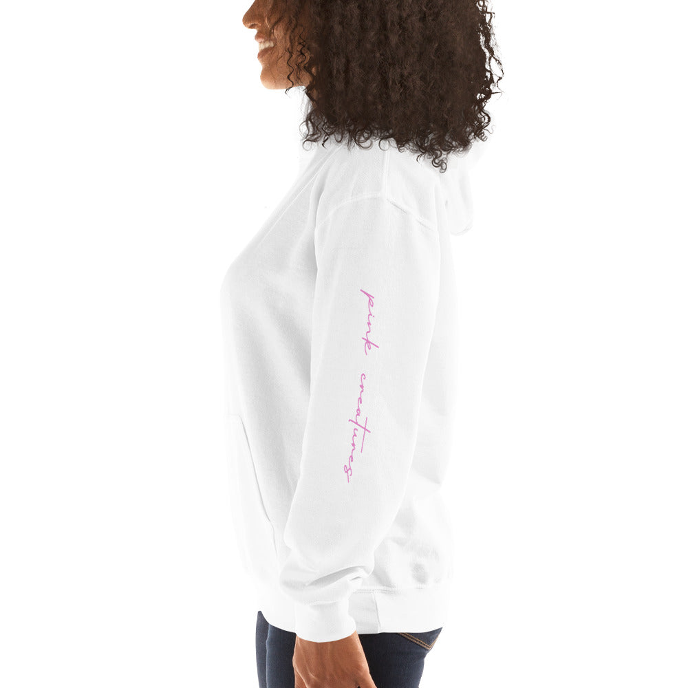 pink creatures title in pink hoodie